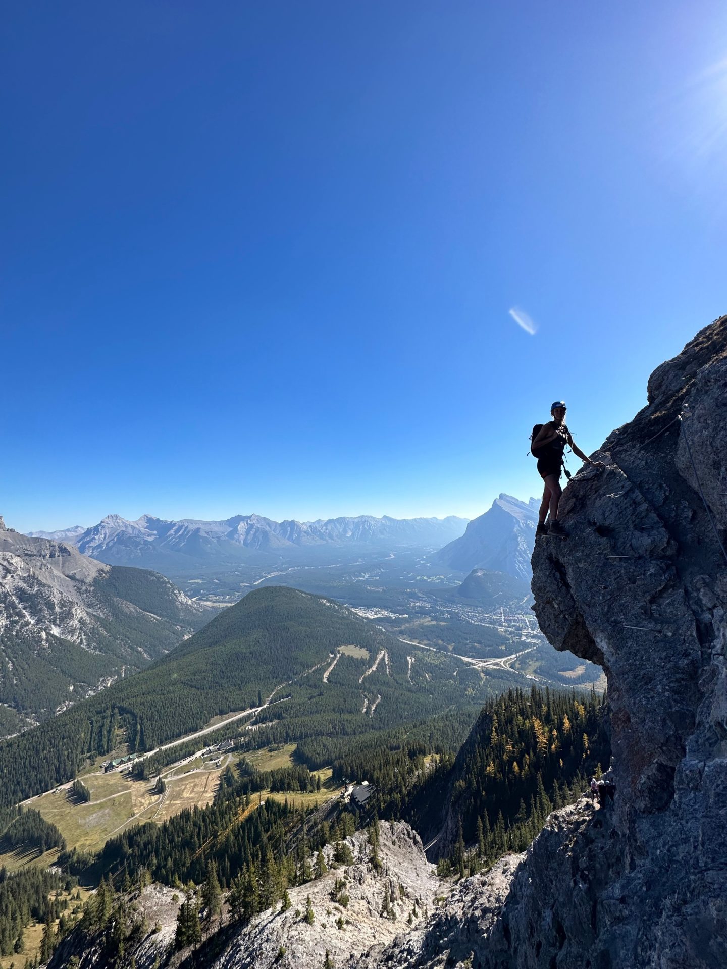 Zanna van Dijk stands on the side of a mountain, attached to the Mount Norquay via ferrata in Banff, the Rockies - Canada Road Trip Itinerary