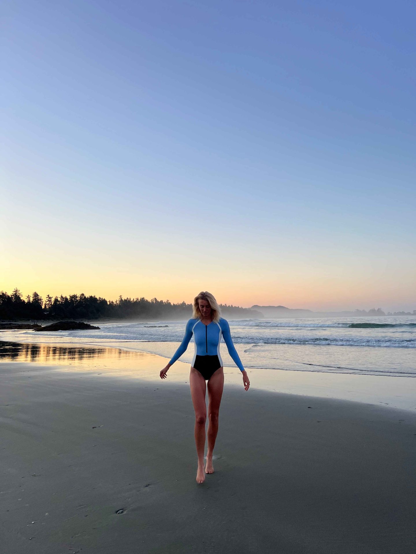 Zanna van Dijk wearing Stay Wild Swim on the beach in Tofino at dusk - Canada Road Trip Itinerary