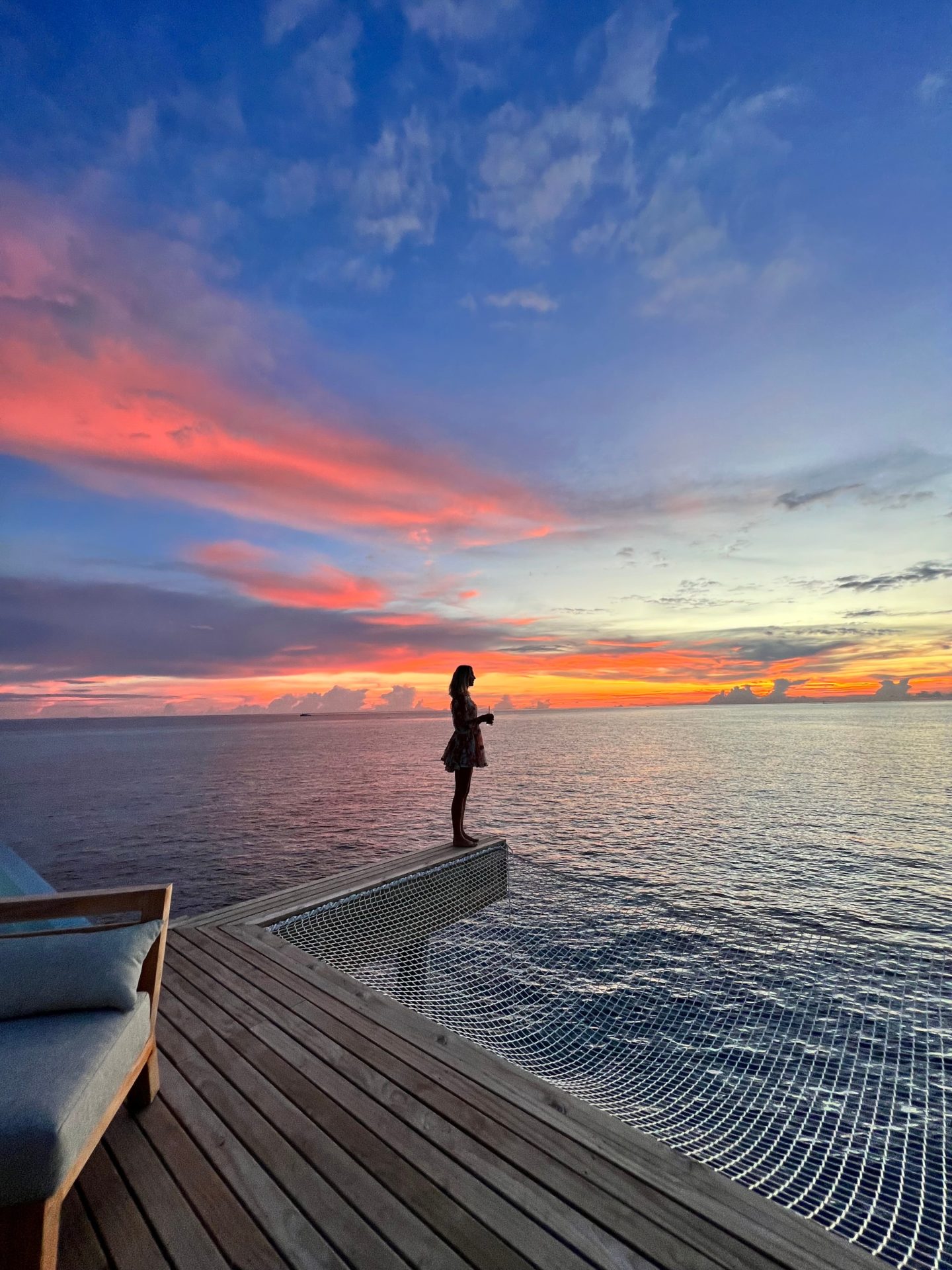 Zanna van Dijk looking out to sea at sunset in the Maldives