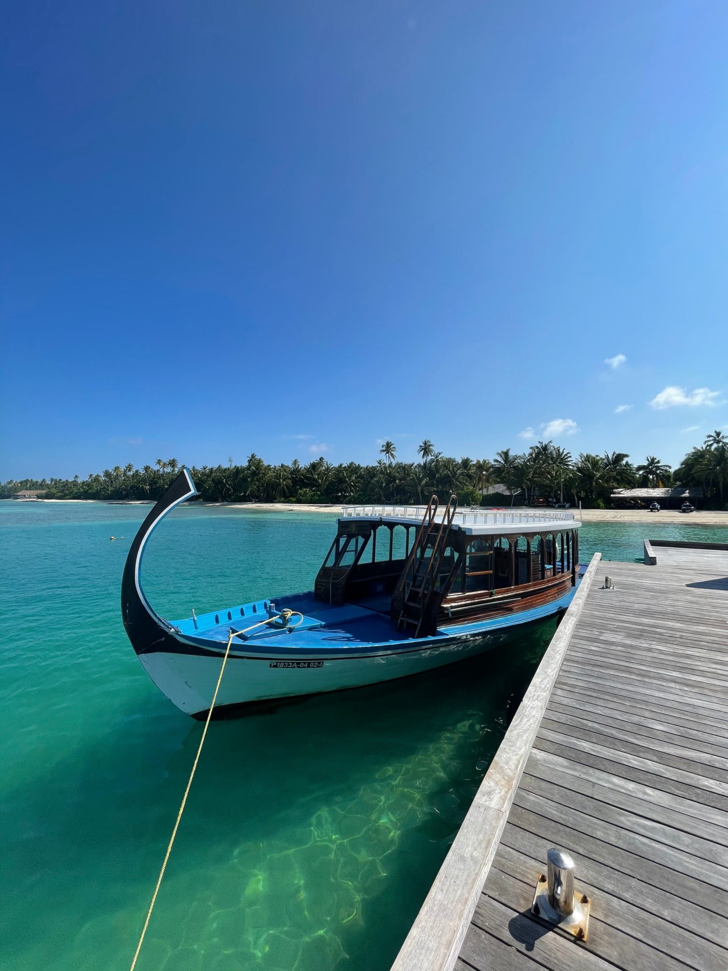 A boat docked next to a jetty in the Maldives