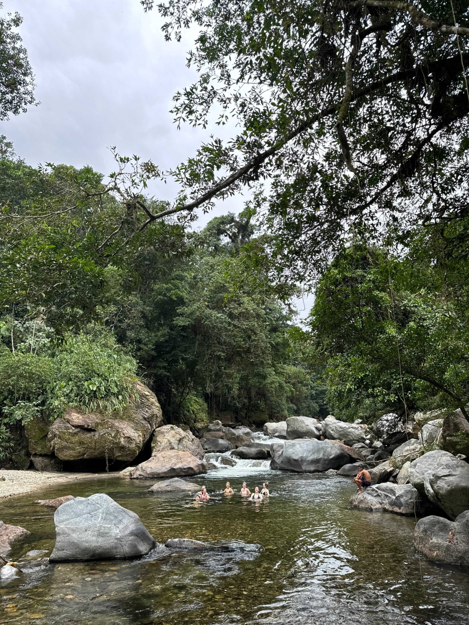 Guest swim in a river on the Lost City Trek in Colombia